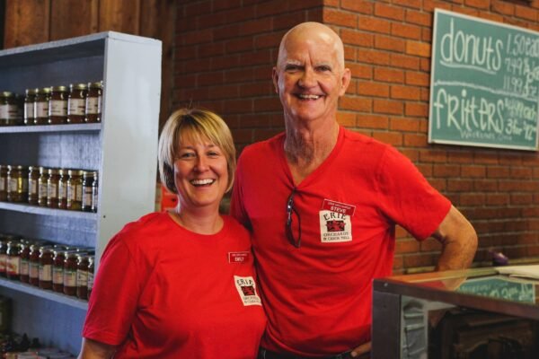 smiling mature owners of cafe