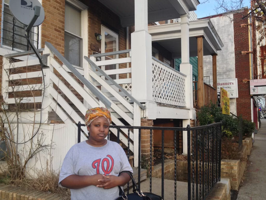 Woman in front of NE DC house highlights affordable housing crisis