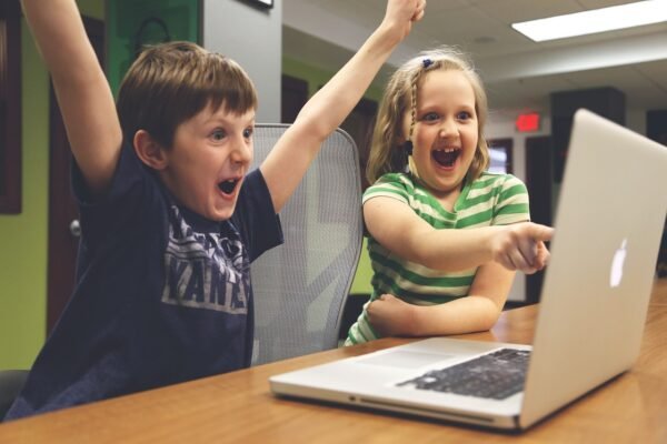 children ecstatic at a laptop